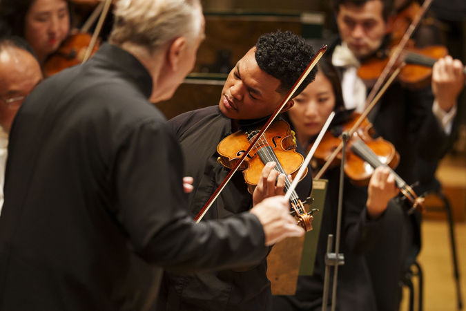 Closeup action shot of violinist Randall Goosby
