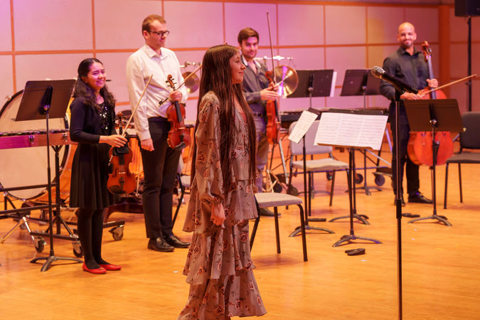 young composer standing for applause