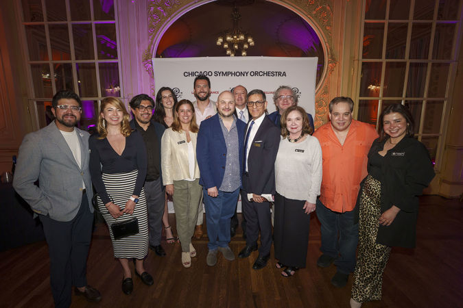 A group shot of several Latino Alliance members and CSO principal trumpet Esteban Batallán