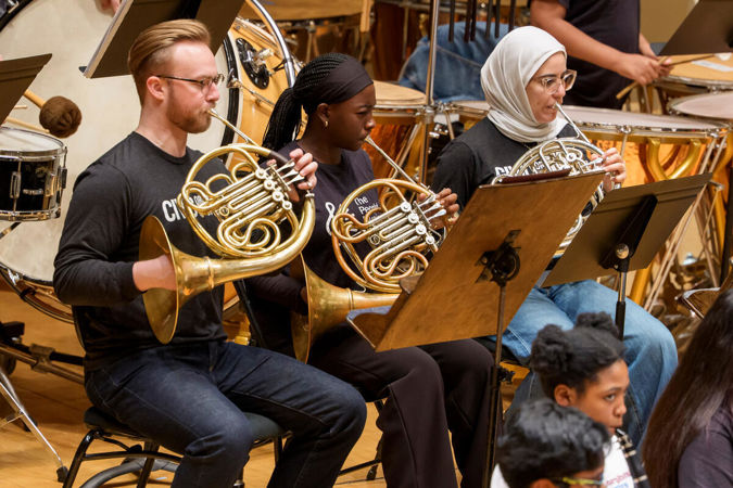 Civic horn players with student
