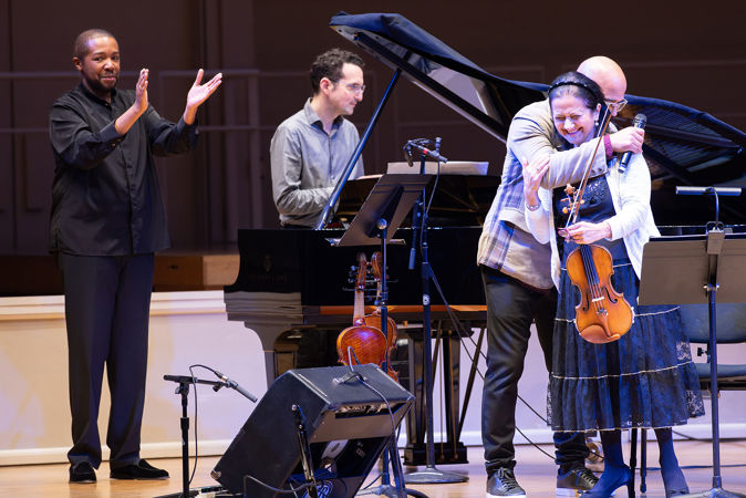 the performers hug and give a bow