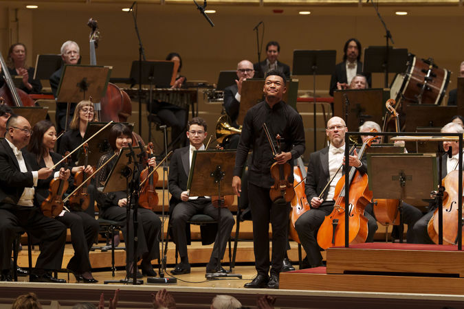 Closeup shot of violinist Randall Goosby bowing after his debut performance of Florence Price's Second Violin Concerto
