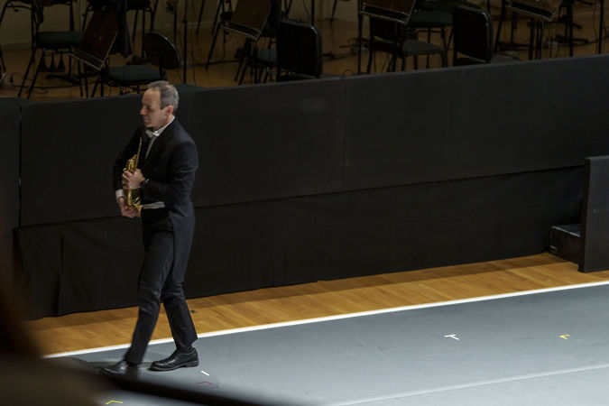 Horn player Oto Carrillo walks off stage during the last movement of Haydn's Farewell Symphony