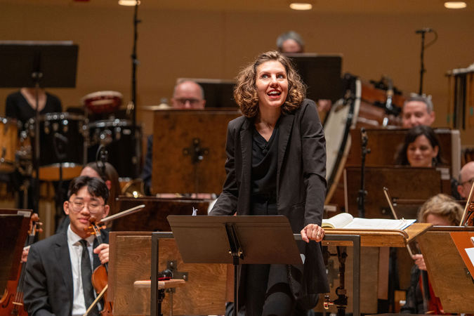 conductor speaking from stage