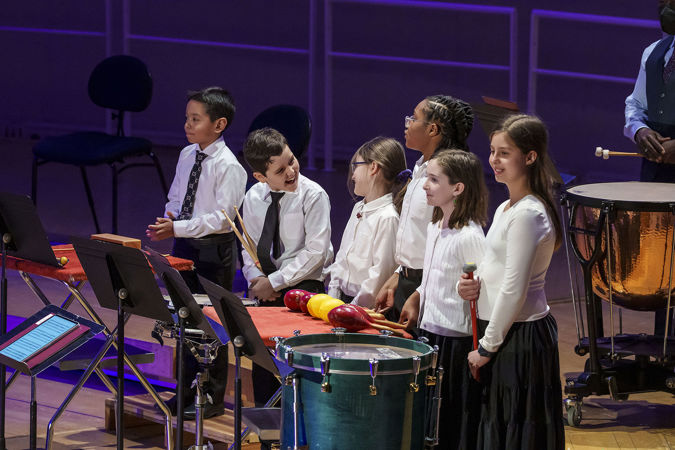 Percussion Scholarship Program students on smiling on stage