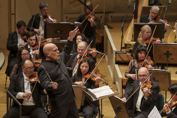 Closeup action shot of conductor Jaap van Zweden on the podium