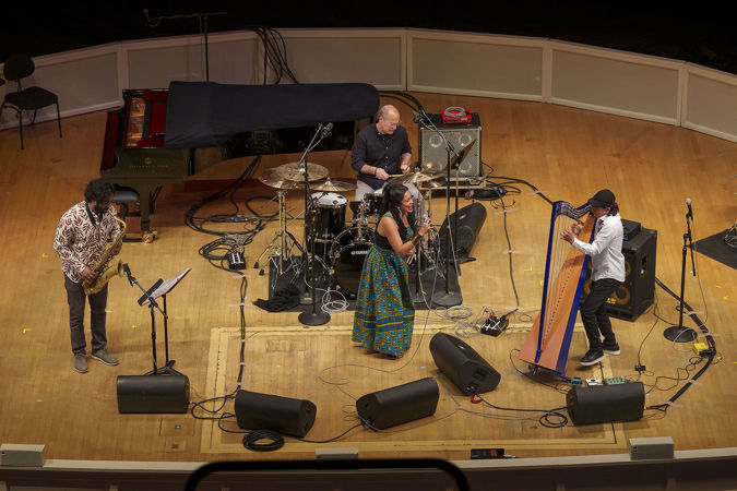 harpist Edmar Castañeda and his quartet, including saxophone, drums and vocals, perform a song together