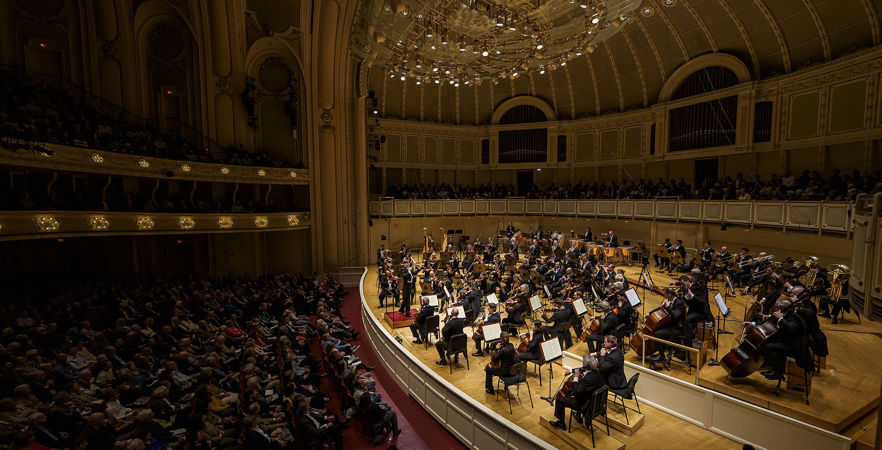 a panorama of the audience and orchestra during the performance