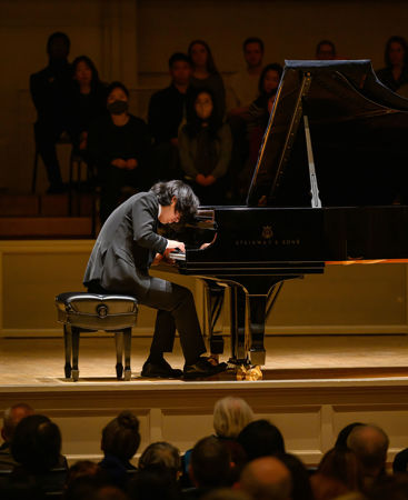 head bowed over the piano, Yunchan Lim performs Bach's Goldberg Variations