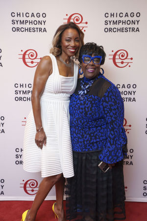 Singer Heather Headley takes photos with a fan postconcert