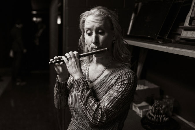 Jennifer Gunn warms up on piccolo backstage