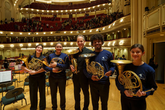 horns posing on stage