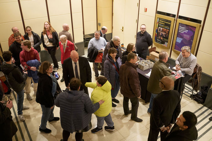 Sam Quinones, author of The Perfect Tuba, signs copies of his book in a crowded Rotunda after the concert