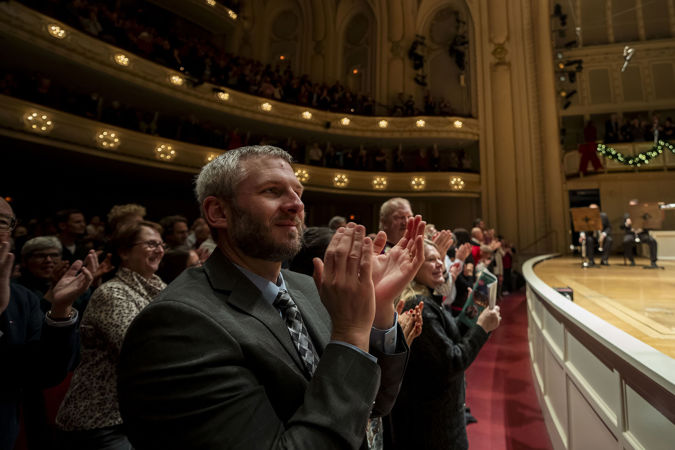 audience members on the main floor applauding