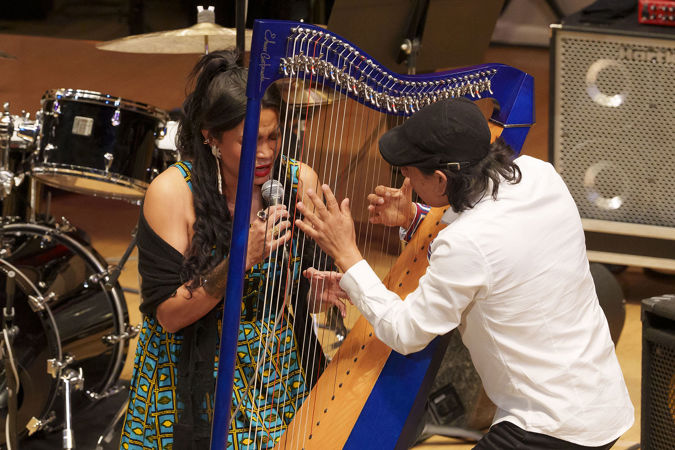 jazz harpist Edmar Castañeda and vocalist Andrea Tierra lean in close during a piece