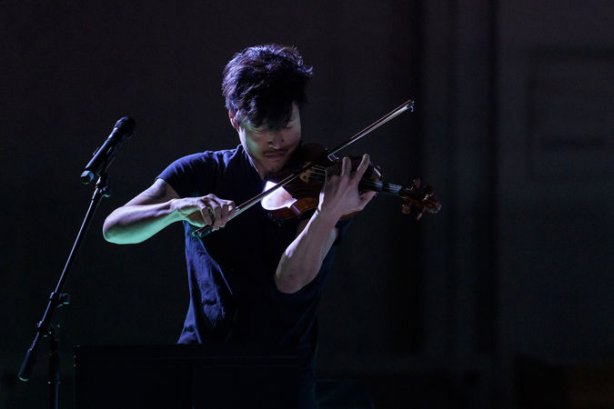 violinist Charles Yang of trio Time for Three performs in shadow
