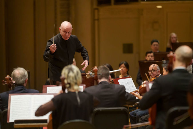 conductor leading orchestra