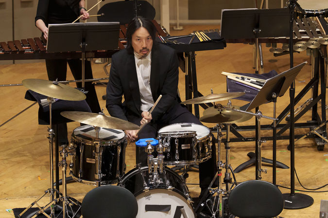 guest percussionist Ian Ding sits at the drum kit and focuses intently, waiting for his cue