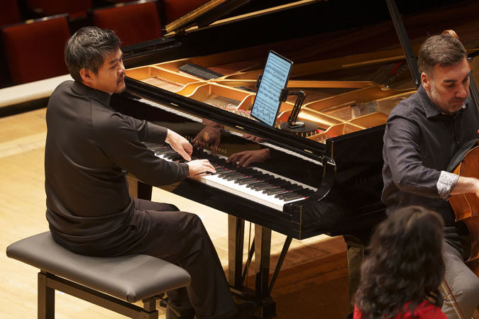 Closeup of pianist Winston Choi performing on stage