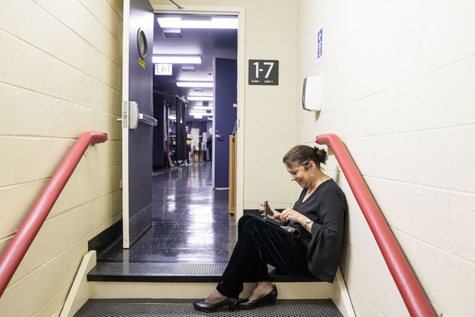 Closeup action shot of CSO assistant principal oboe Lora Schaefer selecting her reed backstage
