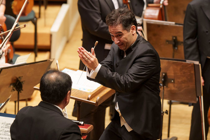 conductor acknowledging orchestra