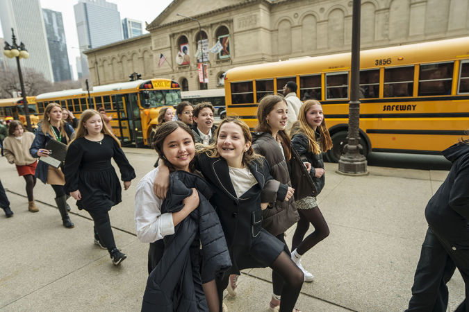 A group of students smiling outside of Symphony Center on Michigan Avenue