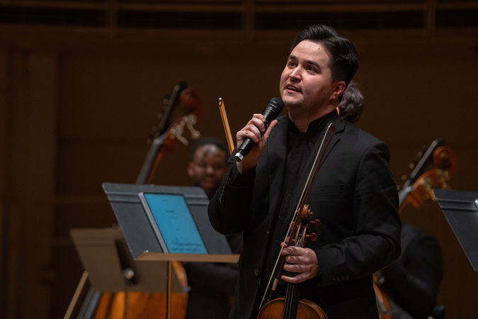 violist Robert Alvarado Switala announces the first piece, Scott Joplin's Overture to Treemonisha