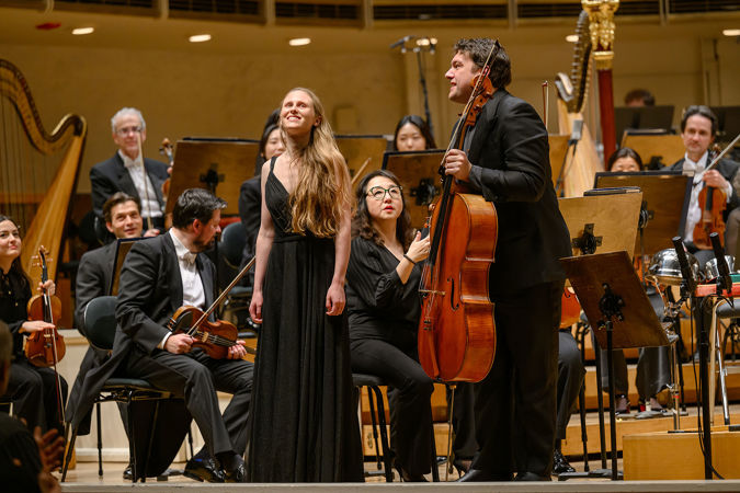 composer Gabriella Smith and cellist Gabriel Cabezas smile and acknowledge the applauding audience after the performance