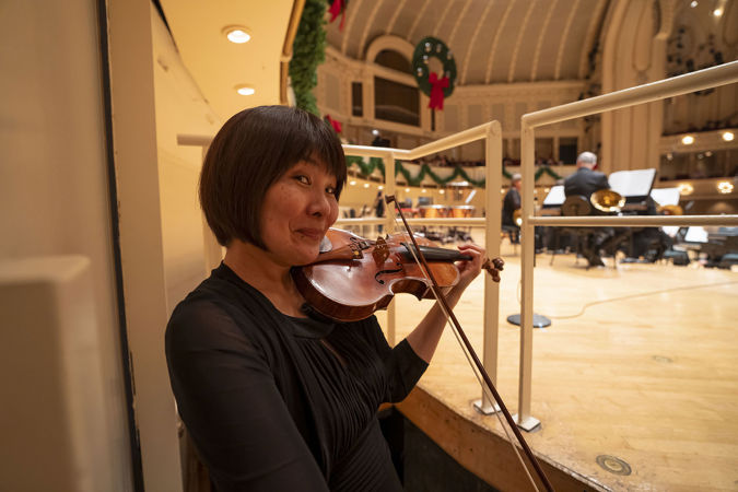 CSO violinist Kozue Funakoshi warms up backstage