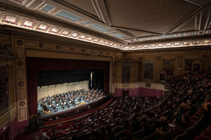 a full view of the auditorium at Morton East High School while the orchestra plays