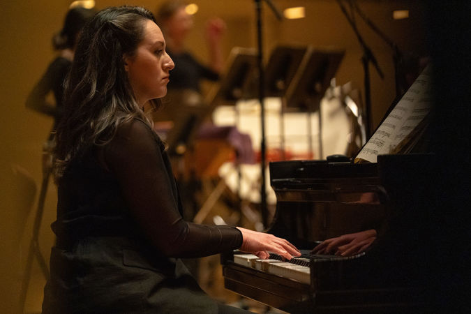 Closeup shot of CSO piano Kelly Estes on stage