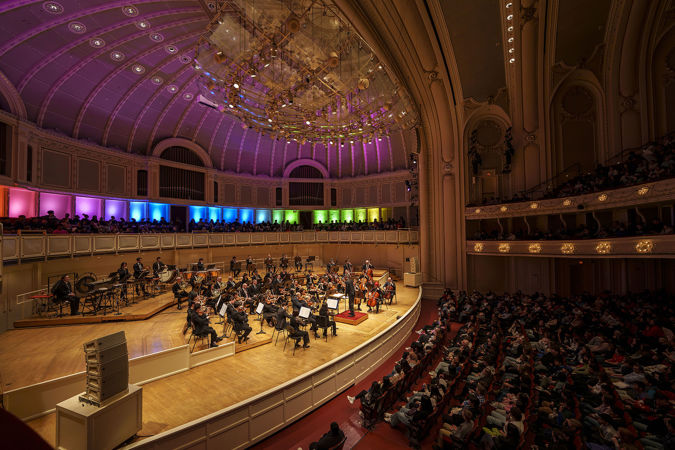 A wide shot of conductor Thomas Wilkins leading members of the CSO at Community Pride, a CSO for Kids concert