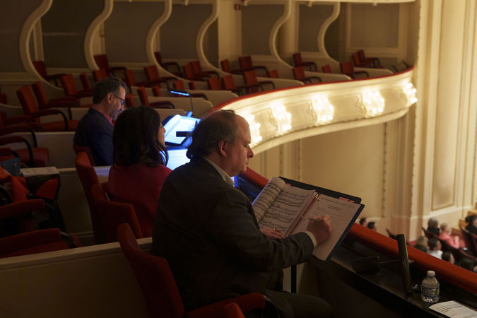 A side view of the four 2025 Young Artists Competition judges reading the score and taking notes on the Box Level