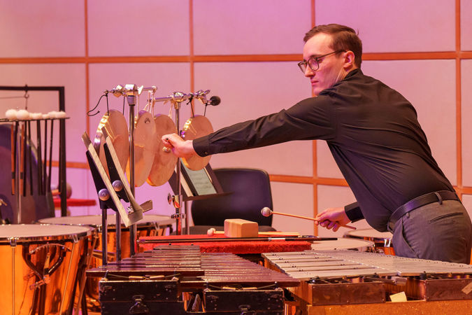 percussionist hitting gong